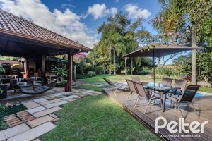 Casa em Condomínio à venda com 450m², 6 dormitórios, 4 suítes, 2 vagas, no bairro Terra Ville em PORTO ALEGRE