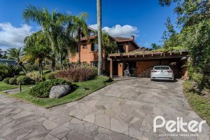 Casa em Condomínio à venda com 450m², 6 dormitórios, 4 suítes, 2 vagas, no bairro Terra Ville em PORTO ALEGRE