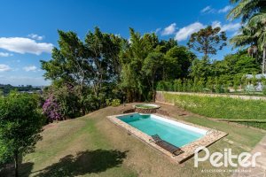 Casa em Condomínio à venda com 565m², 5 dormitórios, 3 suítes, 4 vagas, no bairro Cavalhada em Porto Alegre