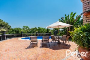 Casa em Condomínio à venda com 459m², 4 dormitórios, 4 suítes, 3 vagas, no bairro Cavalhada em PORTO ALEGRE