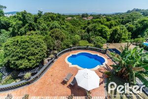 Casa em Condomínio à venda com 459m², 4 dormitórios, 4 suítes, 3 vagas, no bairro Cavalhada em PORTO ALEGRE