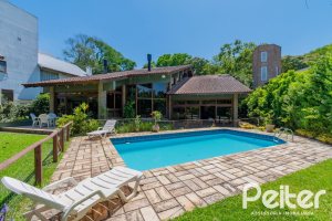 Casa em Condomínio à venda com 600m², 4 dormitórios, 2 suítes, 5 vagas, no bairro Cavalhada em PORTO ALEGRE